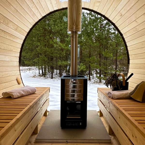 Showcasing the inside of a wooden barrel sauna.
