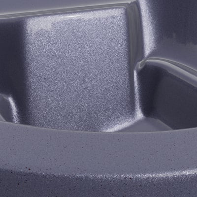 Close-up of metallic textured surface with smooth edges and subtle speckled finish on curved structure