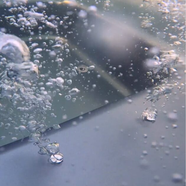 Underwater view of air bubbles rising inside a hot tub during active massage circulation.