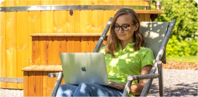 Customer managing hot tub order outdoors using a laptop