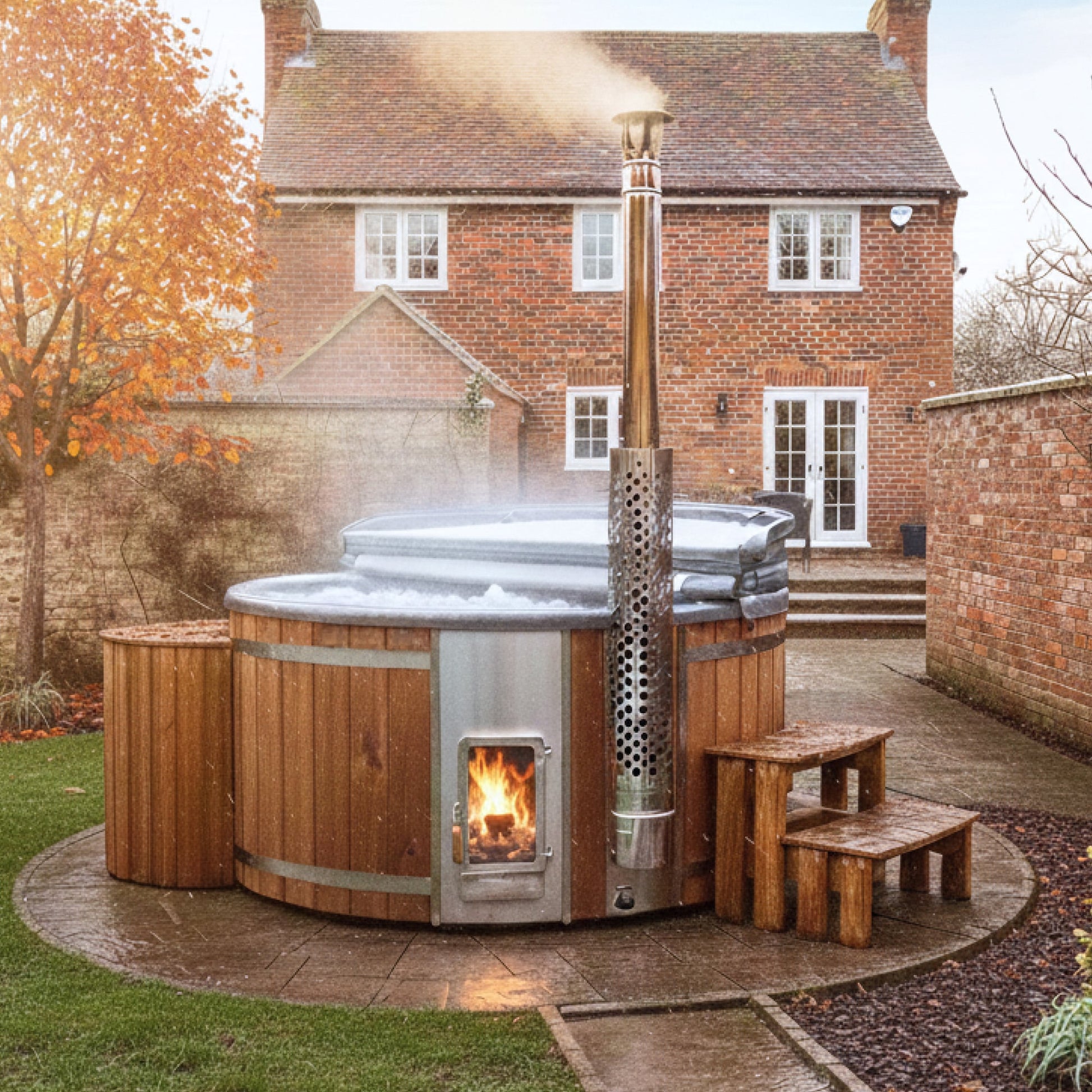 Outdoor view of premium sand filter wood fired hot tub with integrated stove, wooden steps, and steam rising in garden setting